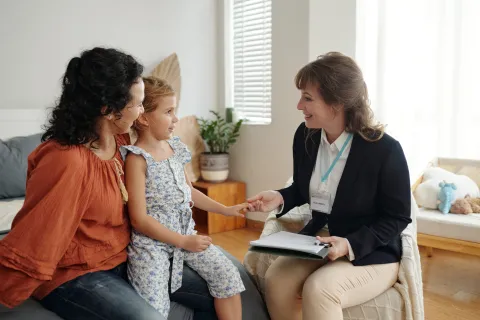 social worker speaking with mother and child